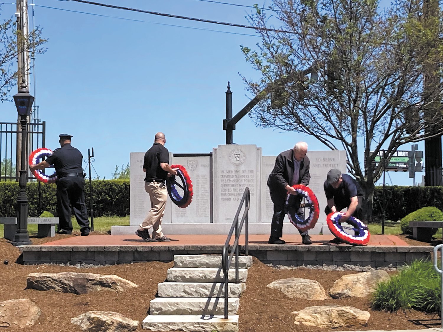 LAYING OF THE WREATHS: To honor law enforcement officers who lost their lives, individuals from the International Brotherhood of Police Officers, Cranston Police Relief Association, Cranston Police Retirees’ Association and Fraternal Order of Police laid the wreaths outside the Cranston Police Department.